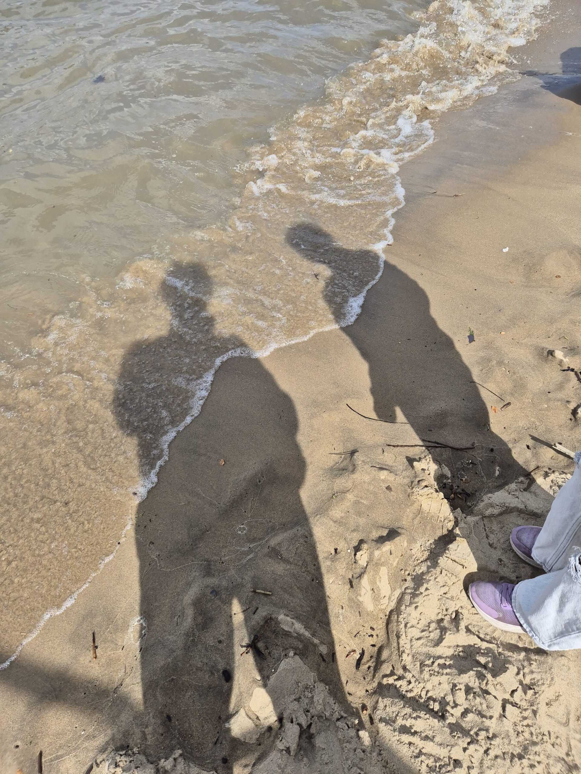 L&B's shadows on beach with tide