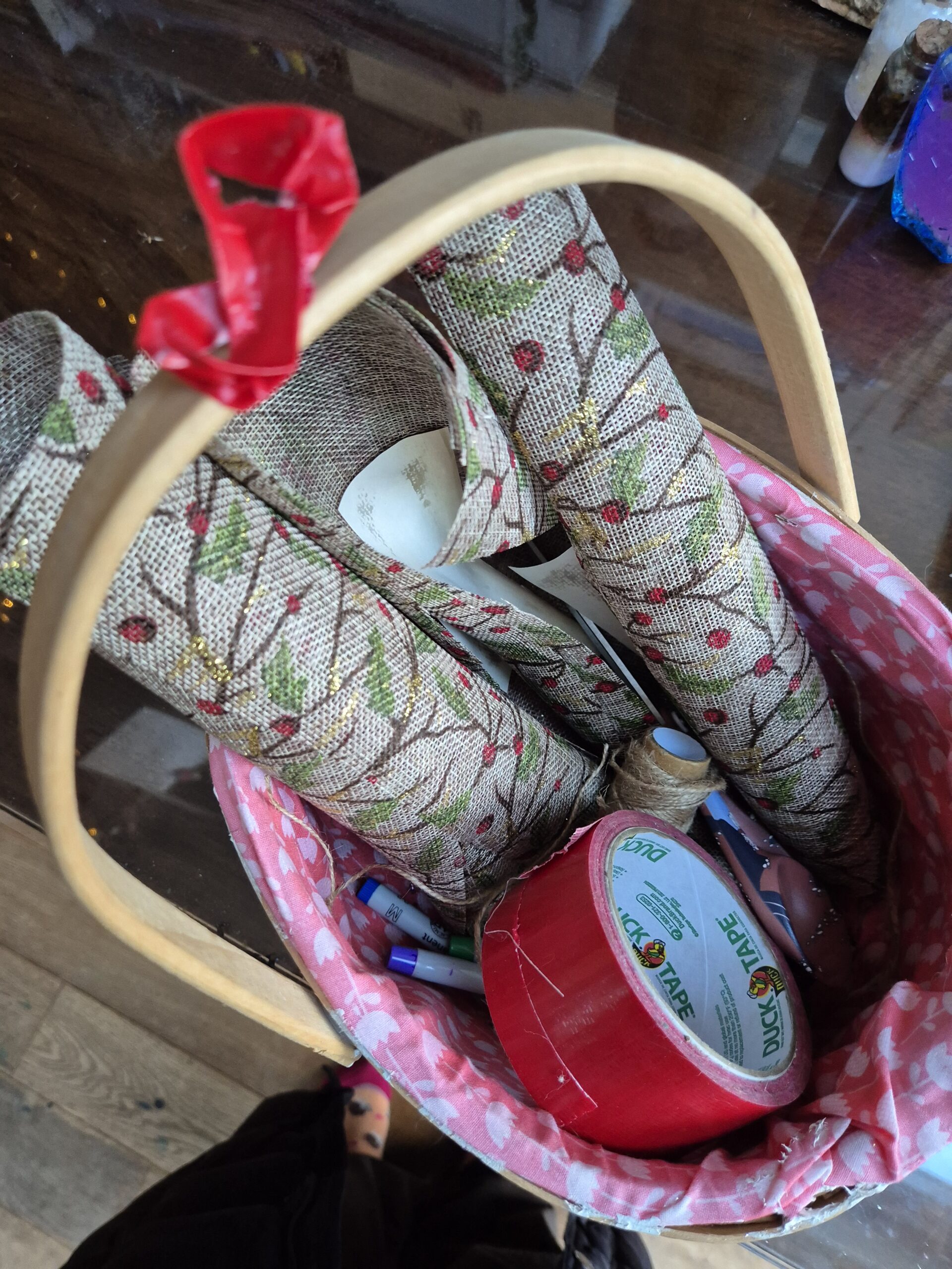 Basket with tape, rolls of material and paper