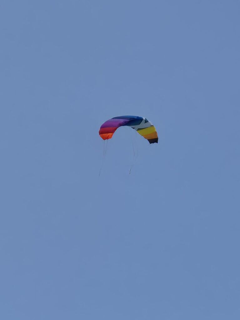A multi-coloured kite flying