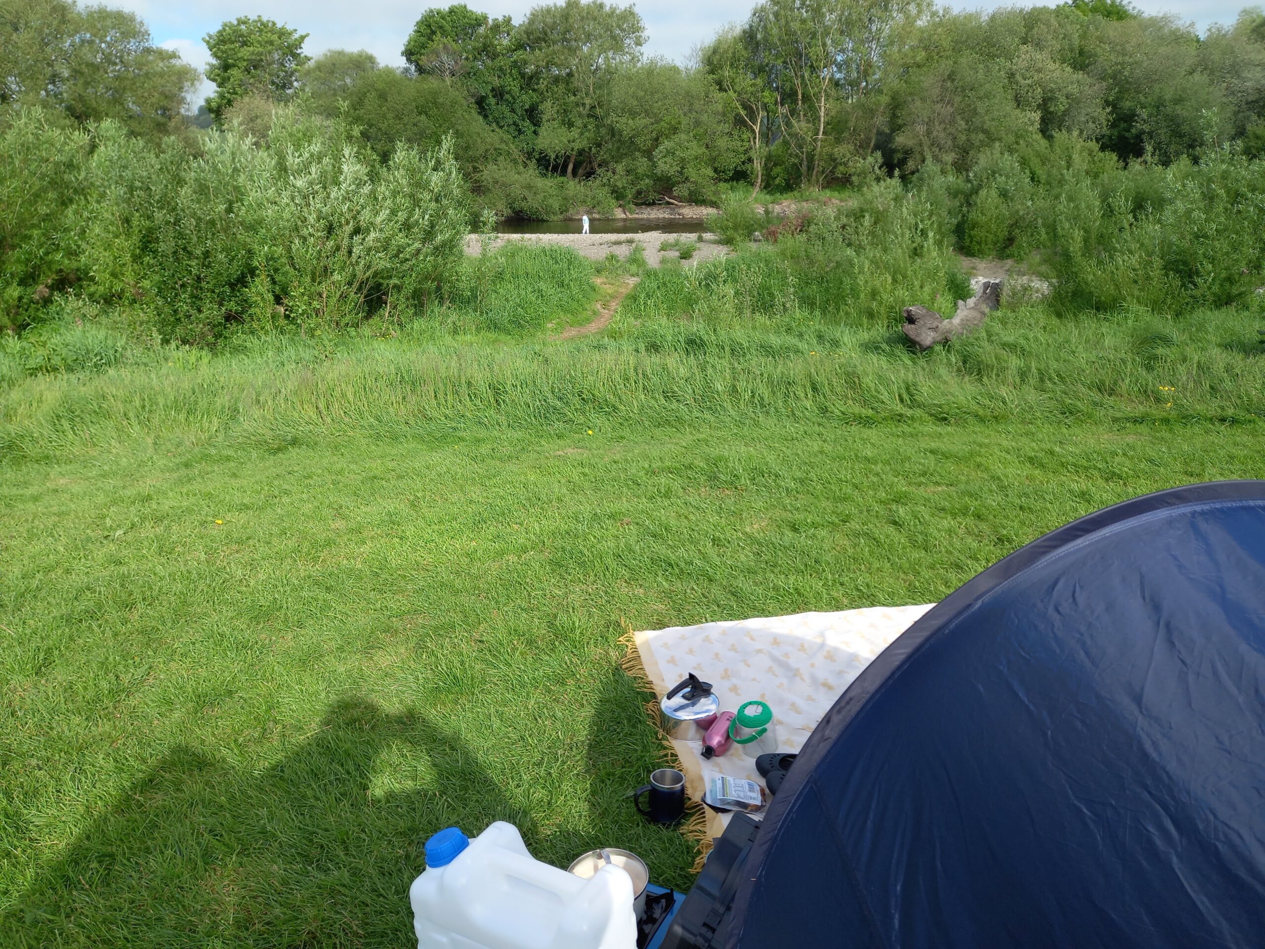 A tent looking out on a river